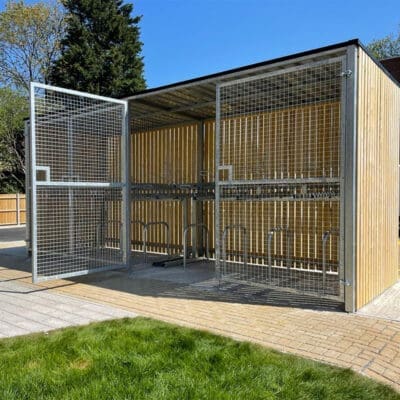 wooden bike shelter with swing mesh gate outside