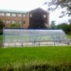 40 Space Original Enclosure installed in a grassy field outside of an apartment block