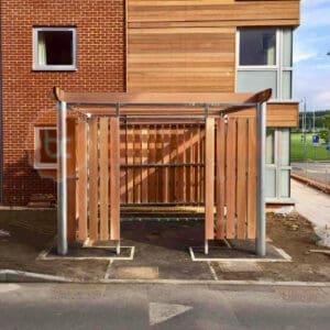 A wooden bin storage structure outside of a building.