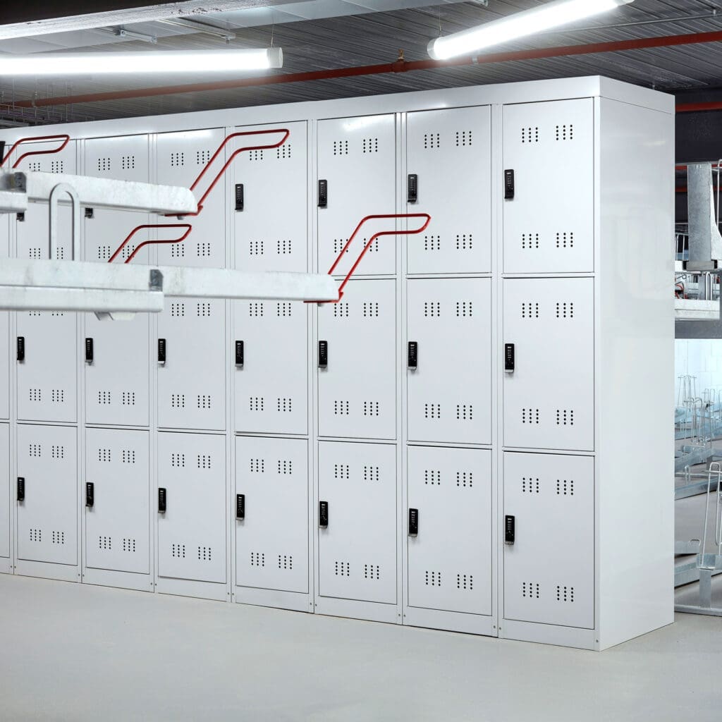 3-Tier Folding Bike Locker installed in an internal cycle storage facility with Two Tier Racks in front
