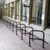 The Crossbar Cycle Stands in a row installed outside a school building, in galvanised RAL colour black