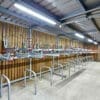 Gas Assisted Two Tier Cycle Racks with Sheffield Stand Lowers installed in a Wooden Cycle Storage Unit with Lighting Installed