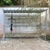 bike shelter outside with a bike hanging vertically