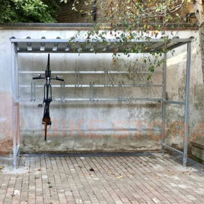 bike shelter outside with a bike hanging vertically