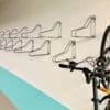 Vertical Bike Rack installed on a white brick wall in an underground bike storage facility