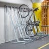 Semi Vertical Bike Rack installed in an underground cycle storage facility next to Timber Fence Slats and bike being stored semi-vertically