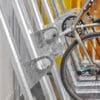 Close up of Semi Vertical Bike rack locking hoops with a bike tire in the distance being locked up