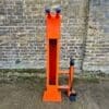 Public Maintenance Bike Stand in RAL colour orange installed outside of a commercial property with a bike pump and various bike repair tools