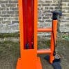 Public Maintenance Bike Stand in RAL colour orange installed outside of a commercial property with a bike pump and various bike repair tools