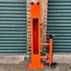 Public Maintenance Bike Stand in RAL colour orange installed outside of a commercial property with a bike pump and various bike repair tools