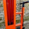 Public Maintenance Bike Stand in RAL colour orange installed outside of a commercial property with a bike pump and various bike repair tools