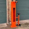 Public Maintenance Bike Stand in RAL colour orange installed outside of a commercial property with a bike pump and various bike repair tools