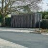Greenwich Cycle Enclosure with wood cladding in RAL black installed at a residential property