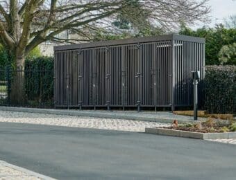 Greenwich Cycle Enclosure with wood cladding in RAL black installed at a residential property