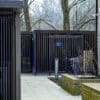Greenwich Cycle Enclosure with wood cladding in RAL black installed at a residential property