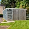a large wooden bike shelter on a lawn