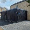 Greenwich Cycle Enclosure with wood cladding in RAL black installed at a residential property