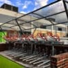 premium chelsea cycle shelter outside with two tier bike racks installed