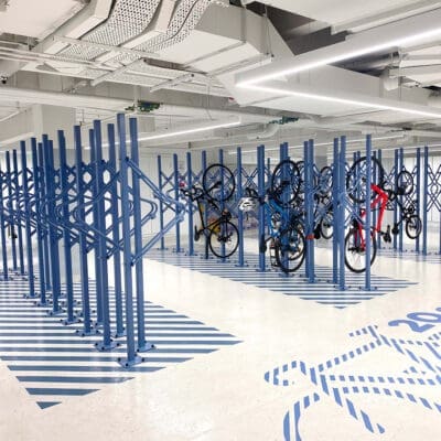 Premium Solo Vertical Bike Rack powder-coated in RAL blue installed in underground storage facility