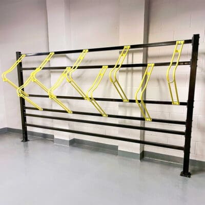 Premium Free Standing Vertical Bike Rack with yellow powdercoating installed in underground cycle storage facility