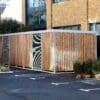 Semi Vertical Amazon Eco Shelter with timber cladding and grey fascia installed outside a commercial building