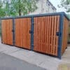 dark wooden cycle shelter with sheffield stands outside a property