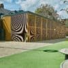 yellow cycle shelter with mesh fencing outside