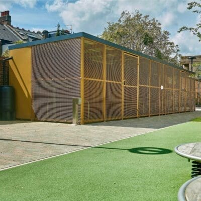yellow cycle shelter with mesh fencing outside