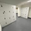 Row of Newham Lockers with white laminate doors and digi code locks installed in an underground end of trip facility