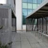 metal bike storage with on the ground bike stands outside an office block