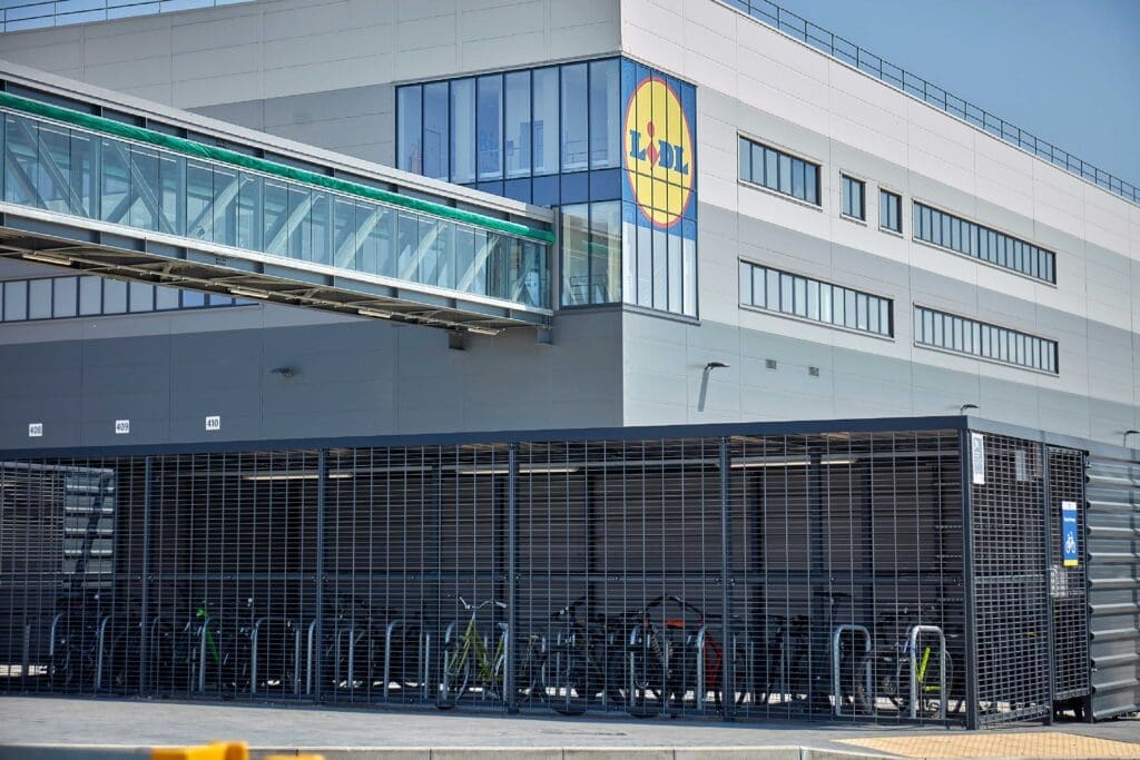 a premium bicycle shed with covered racks outside of a building