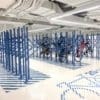 Premium Solo Vertical Bike Racks installed in an underground cycle storage facility in RAL colour blue