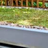 close up of sedum roof installed on top of a wooden cycle shelter outside a residential property