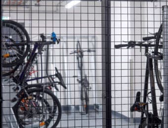 High Security Bike Storage with a RAL mesh fence and Semi Vertical Bike Racks behind it