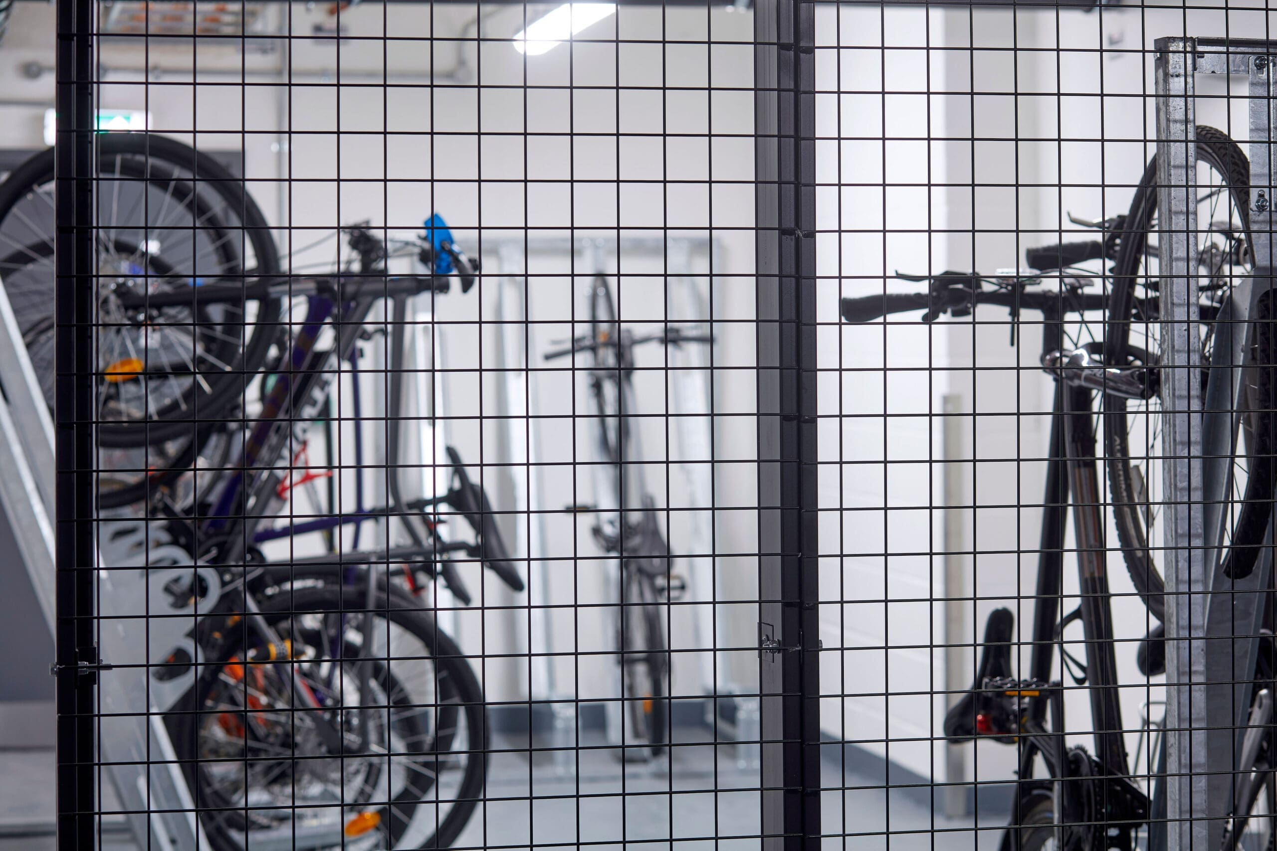 High Security Bike Storage with a RAL mesh fence and Semi Vertical Bike Racks behind it
