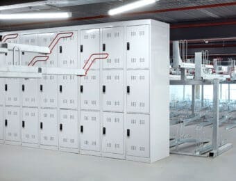 Row of 3-tier folding bike lockers installed internally at a commercial property