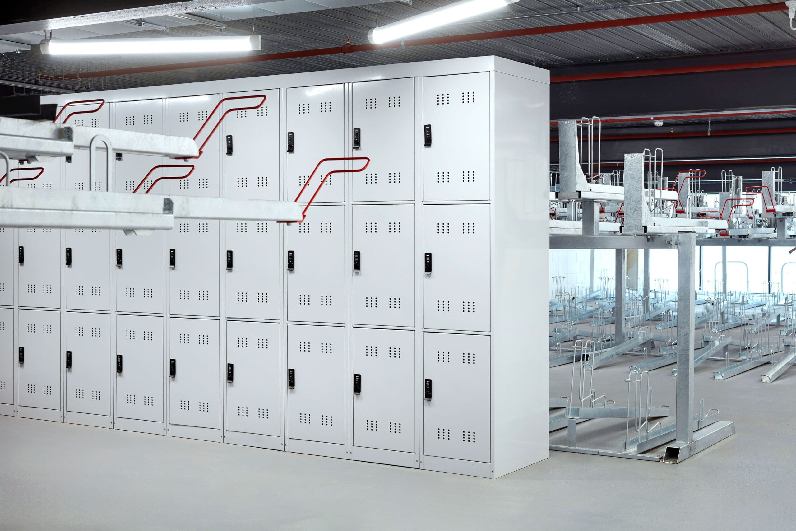 Row of 3-tier folding bike lockers installed internally at a commercial property