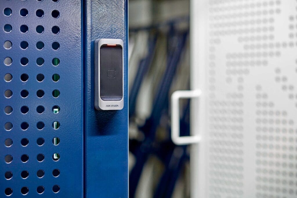 Access control lock with a swing mesh door installed in a secure storage facility