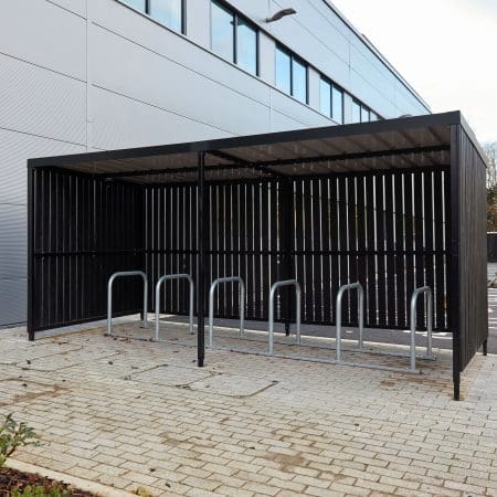10 Space Amazon Eco Shelter with Toastracks installed outside of a Commercial Property cladded in Black Thermopine Wood