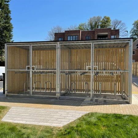 wooden bike shelter with swing mesh gate outside