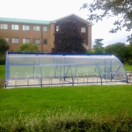 40 Space Original Enclosure installed in a grassy field outside of an apartment block