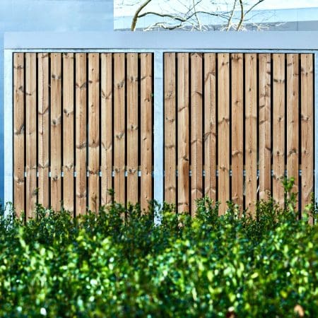 Amazon Eco Semi Vertical Shelter installed outside a commercial property behind a bush