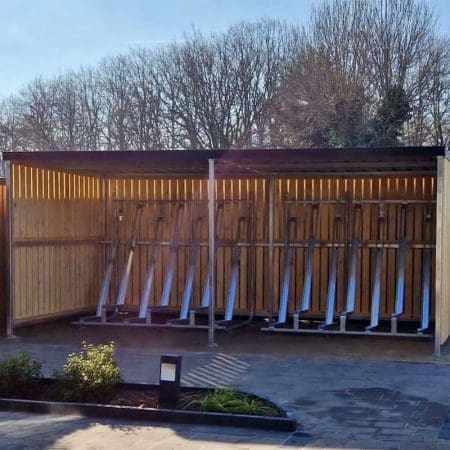 semi vertical bike racks installed in a wooden bike shelter