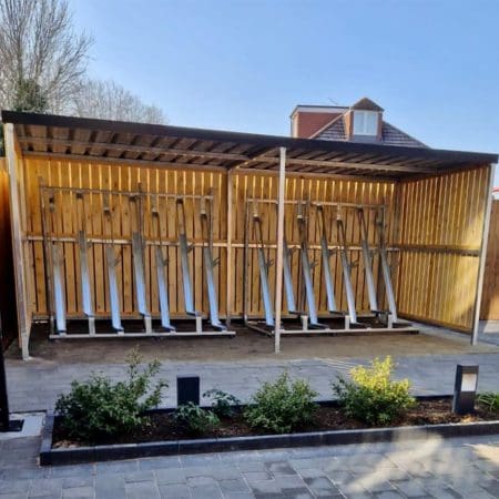 semi vertical bike racks installed in a wooden bike shelter