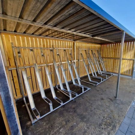 close up of semi vertical bike racks installed in a wooden bike shelter