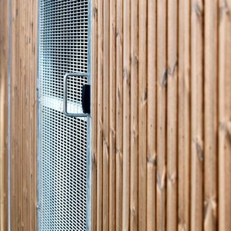 Close up of the Amazon Semi Vertical Cycle Shelter with a mesh swing door and access control