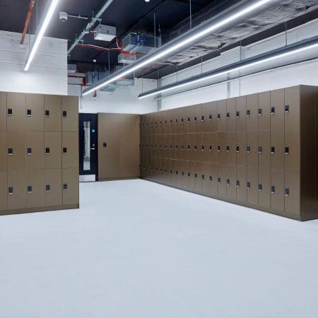 Several Camden Lockers installed in an underground cycle storage area which is focused on end of trip facilities.
