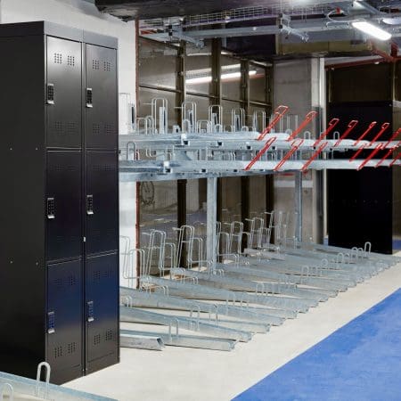 Two Tier Gas Assisted Bike Racks installed in an underground cycle storage facility next to a cycle locker