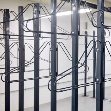 close up of solo vertical bike racks stored in underground cycle storage