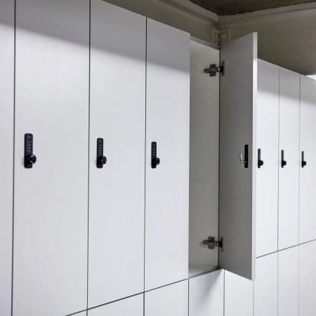 Camden Clothing Lockers with one door open, with white laminate doors and Digi Code Lock installed in an underground bike storage facility.